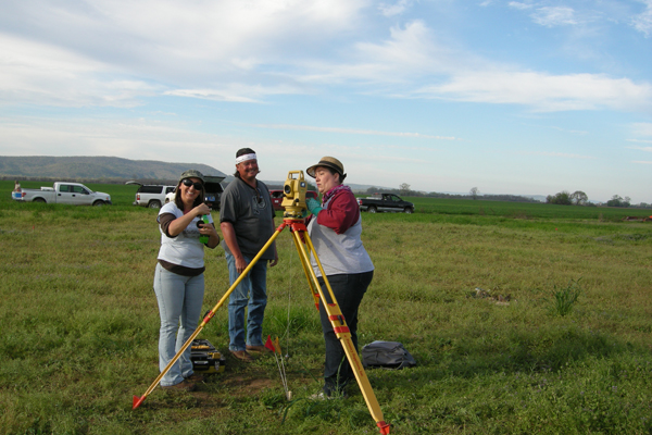 Trini Hadden, Martin Miles, and Trona Wells setting up total station